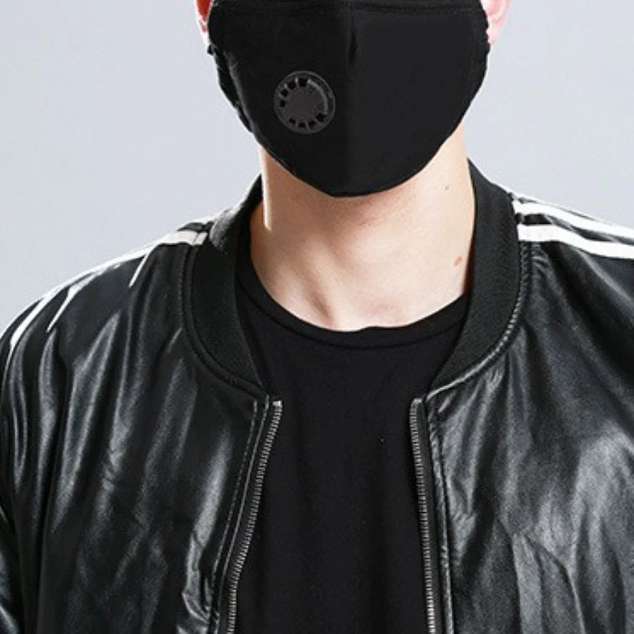 Black cotton face mask with breathing valve worn with a leather jacket