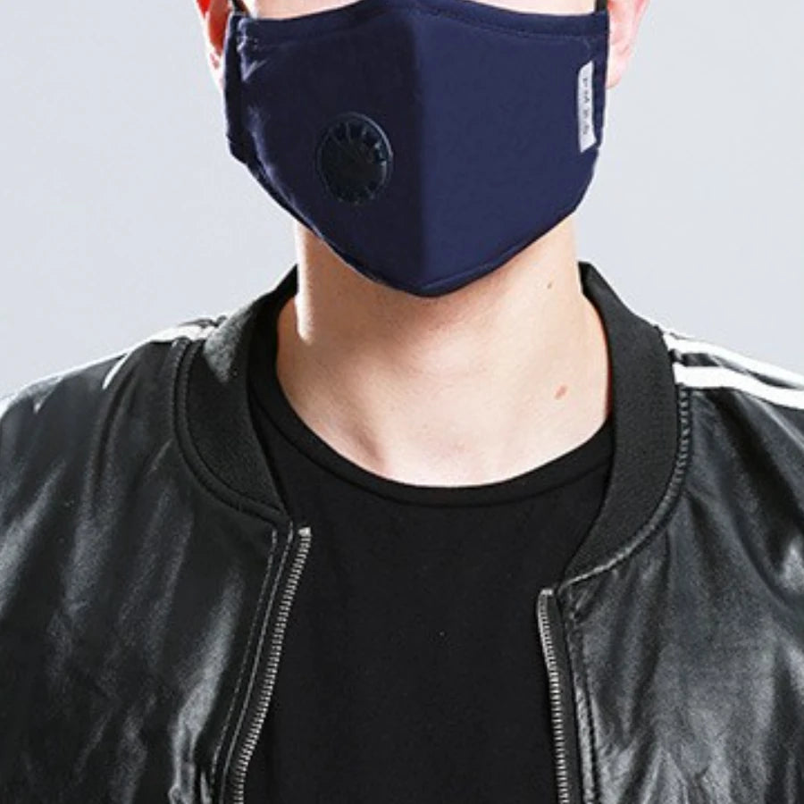 Navy blue cotton face mask with breathing valve worn with a leather jacket