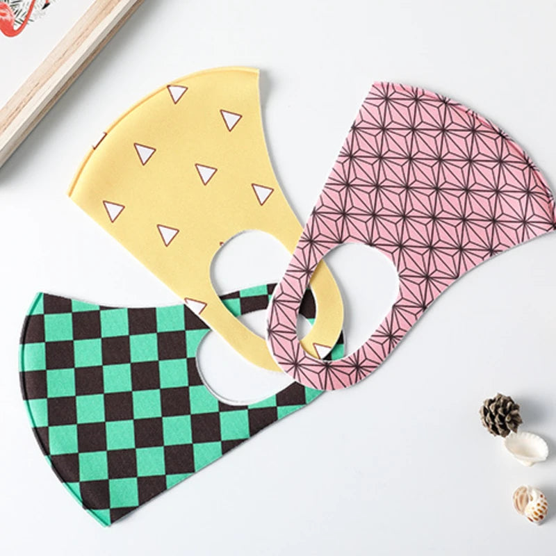 Three printed ice silk face masks laid flat