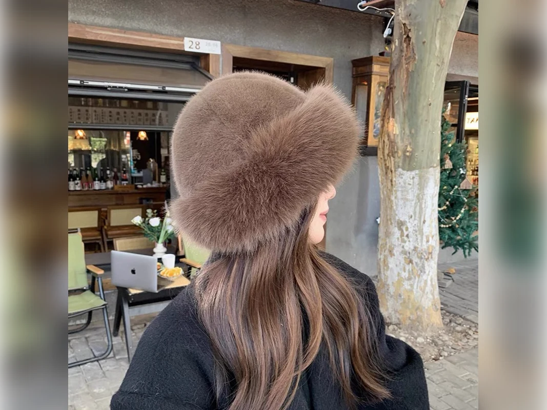 Woman wearing a soft brown faux fur winter hat