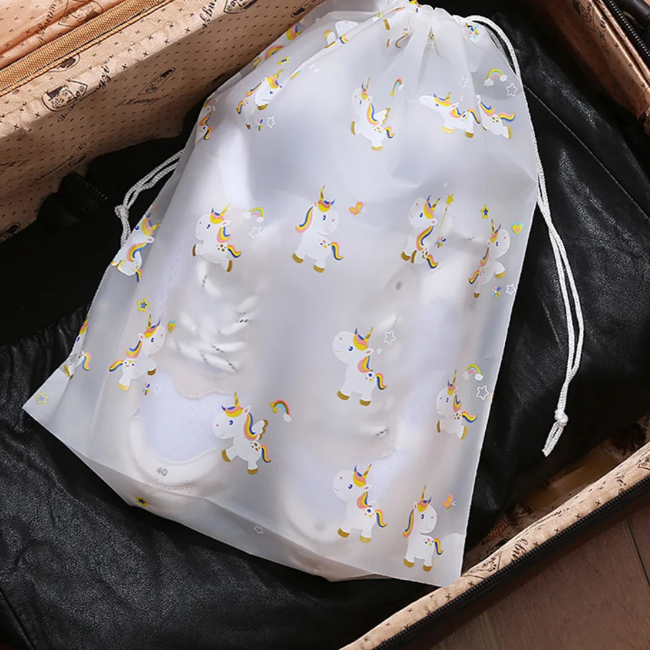 Unicorn print drawstring storage bag packed in a suitcase for travel