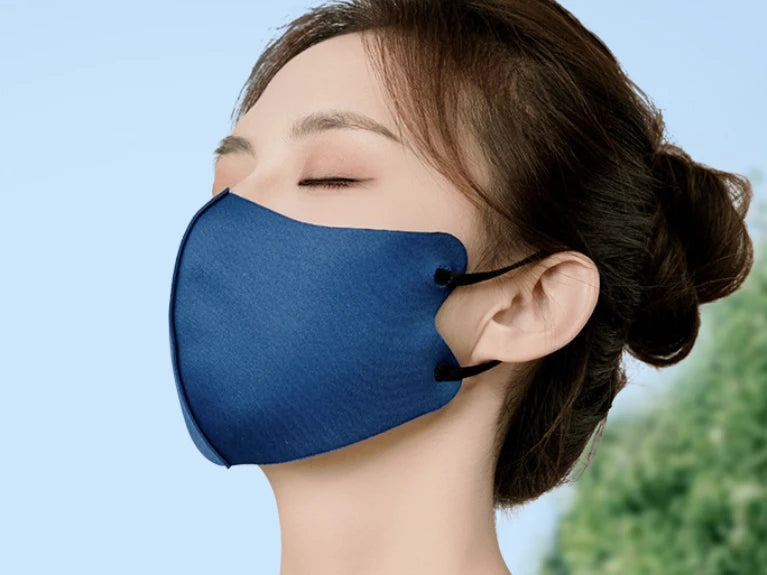 Soft blue 3D face mask worn outdoors