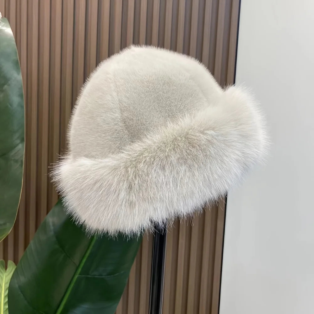 Light beige faux fur winter hat displayed on a stand, showing the fluffy cuff
