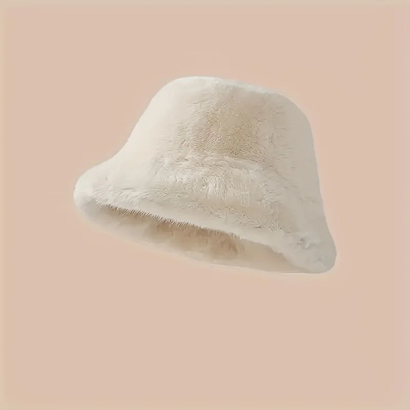 White fluffy bucket hat on a soft peach background