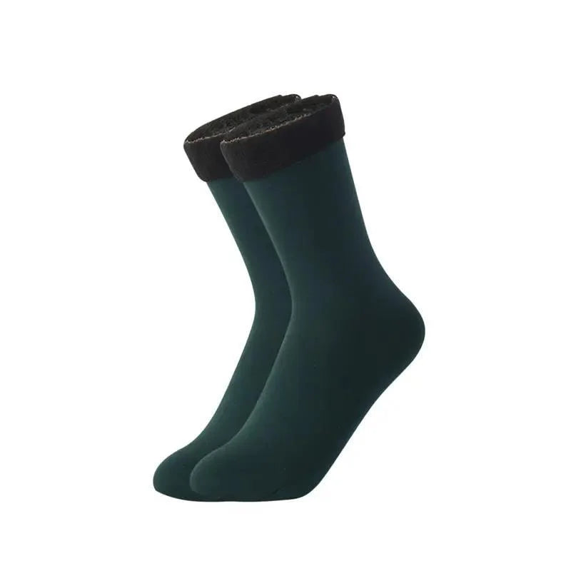 Pair of green velvet thermal socks with black fleece-lined cuffs on a white background