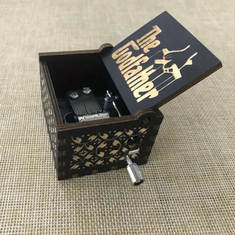 The Godfather music box open, showing the metal music mechanism inside