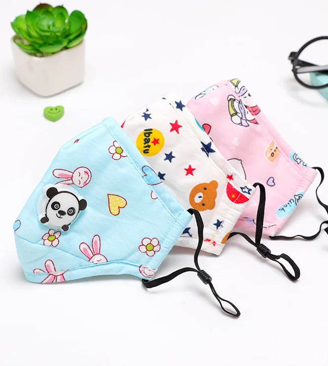 Blue bunny, white stars and pink bear kids face masks laid side by side