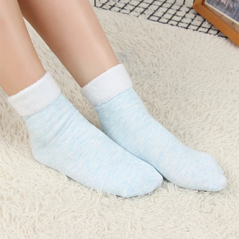 Light blue premium fleece-lined socks worn with white plush cuffs