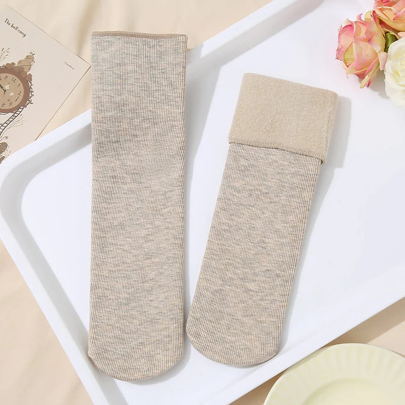 Light brown heather knit fleece-lined socks, one with the plush cuff folded down