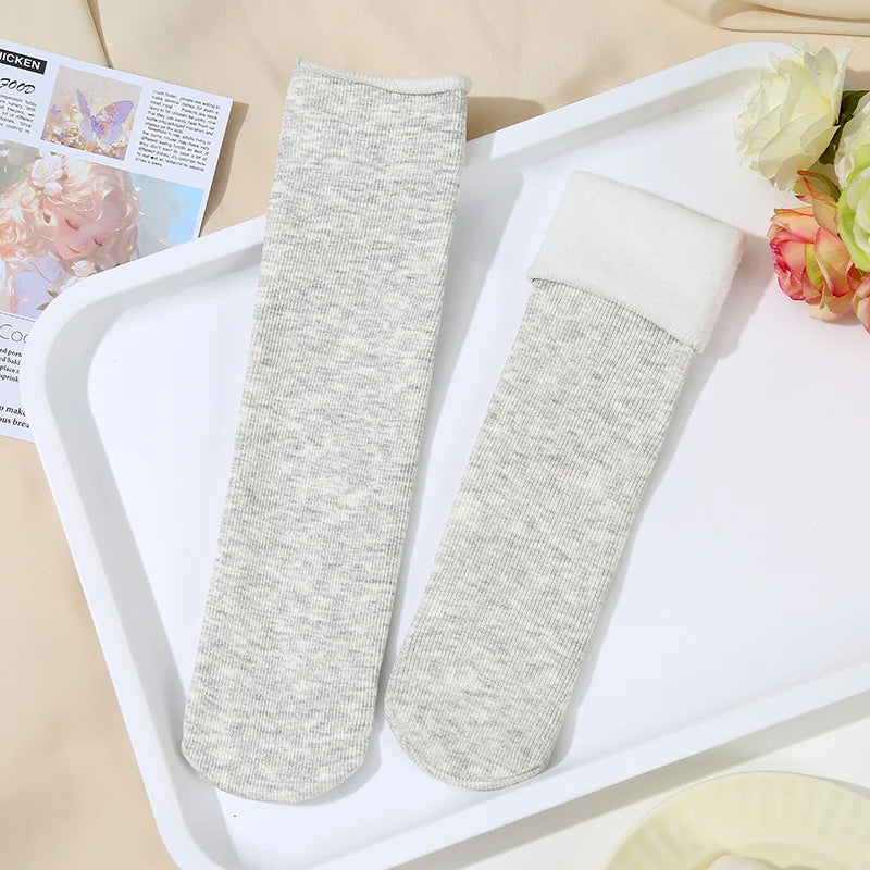 Light grey heather knit fleece-lined socks, one with the white plush cuff folded down