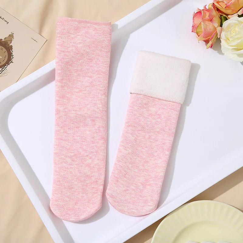 Pink heather knit fleece-lined socks, one with the plush cuff folded down