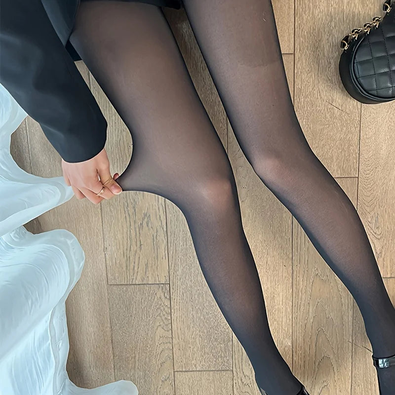 Black sheer-look lined tights worn full length on a wooden floor