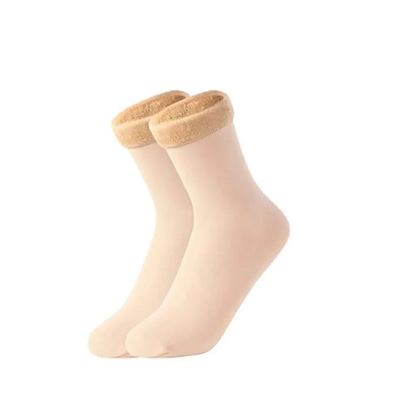 Pair of skin colour velvet thermal socks with plush fleece-lined cuffs on a white background