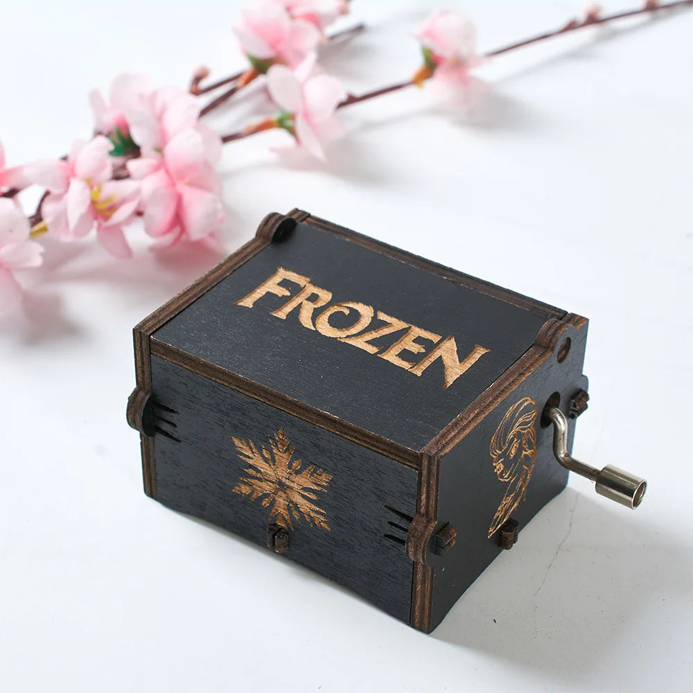 Closed black wooden snow princess music box with engraved lid, snowflake and princess portrait