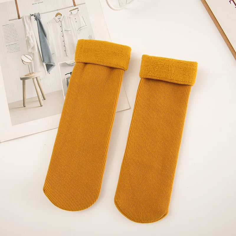 Pair of mustard yellow thick ribbed winter socks with fleece-lined cuffs