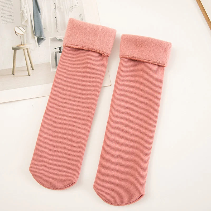 Pair of pink thick ribbed winter socks with fleece-lined cuffs