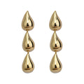 Gold triple teardrop drop earrings on a white background