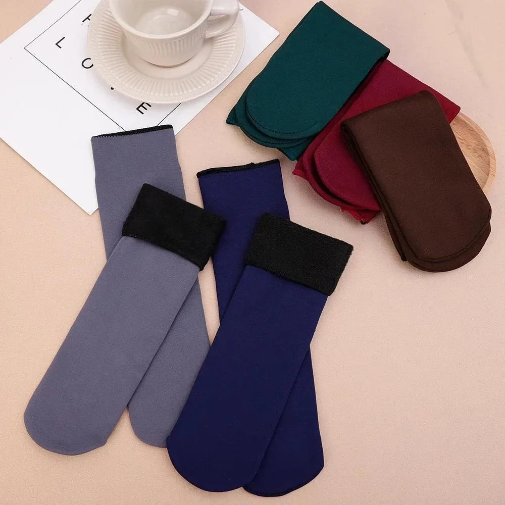 Grey and blue velvet thermal socks showing the fleece cuffs, with green, maroon and brown pairs