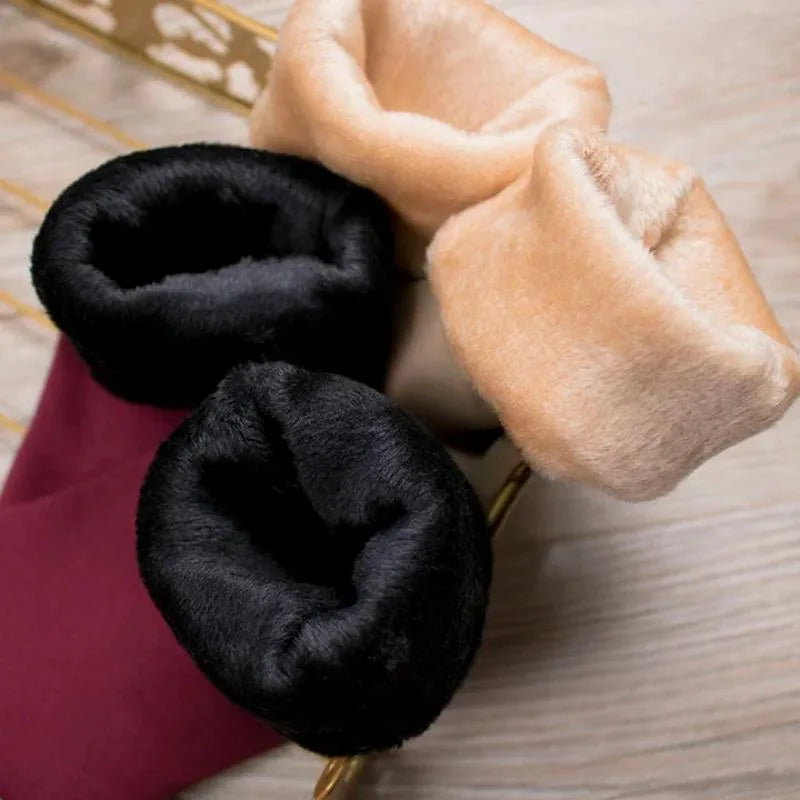 Close-up of the thick plush fleece lining inside black and skin colour thermal socks