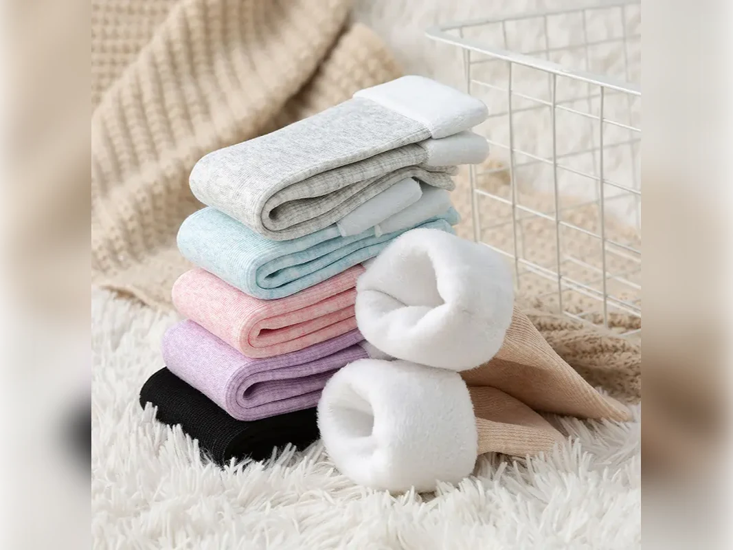 Stack of warm fleece-lined winter socks in soft colours