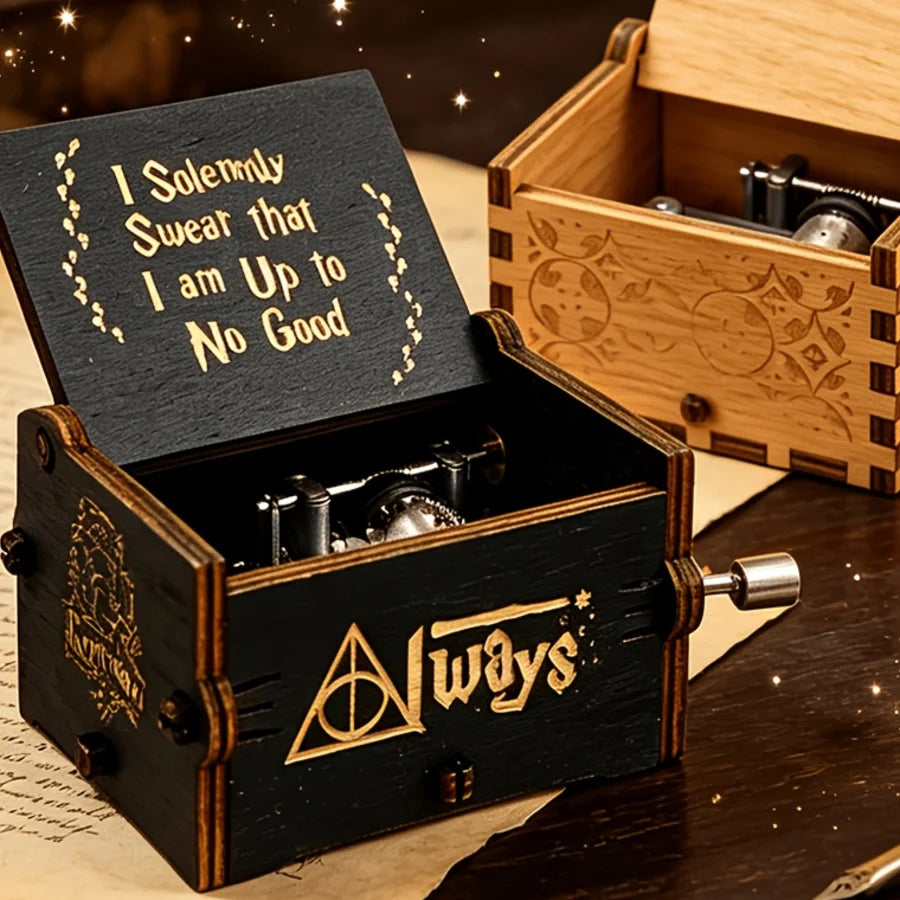 Always engraved black wooden hand-crank music box on a desk with candles and parchment