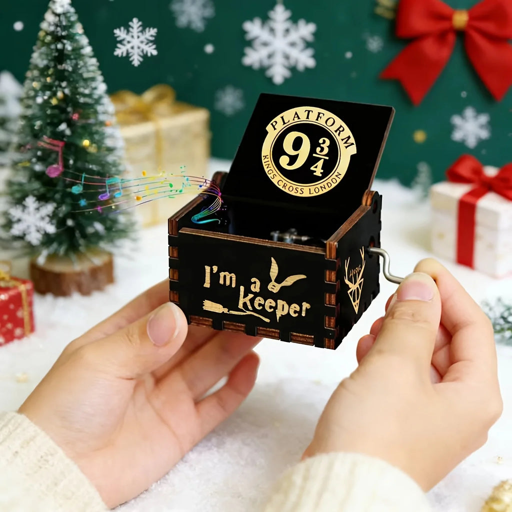 Hands turning the crank of the Platform 9 3/4 wooden music box